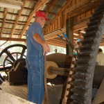 Picture of the veneer mill, its drive gear, and operator