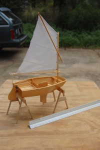 This view from slight to the rear and right side shoes the interior of the boat.  The actual boat is 7 and 1/2 feet long.  The model is about 7 1/2 inches long and 4 inches wide.  The front is square, not pointed which is the pram shape.  The hull is slightly narrower in the front, bows out amidship and tapers slightly to the transom.